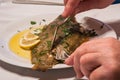 Filleting or Eating Sole Meuniere with Fork and Fish Knife Royalty Free Stock Photo