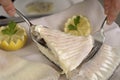 Filleting a poached turbot