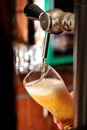 Filling beer glass and tap Royalty Free Stock Photo