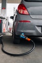 Filling car petrol. Pump gas fuel at gasoline oil station for nozzle tank. Black handle of the refueling gun. Royalty Free Stock Photo