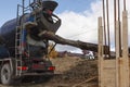 Filling concrete from mixer into wooden formwork Royalty Free Stock Photo