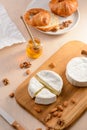 Filling a croissant with honey, almond, walnuts and brie cheese Royalty Free Stock Photo