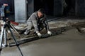 Filling the floor with concrete, screed and leveling the floor by construction workers. Smooth floors made of a mixture of cement Royalty Free Stock Photo