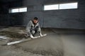 Filling the floor with concrete, screed and leveling the floor by construction workers. Smooth floors made of a mixture of cement Royalty Free Stock Photo