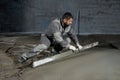 Filling the floor with concrete, screed and leveling the floor by construction workers. Smooth floors made of a mixture of cement Royalty Free Stock Photo