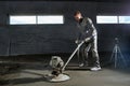 Filling the floor with concrete, screed and leveling the floor by construction workers. Smooth floors made of a mixture of cement Royalty Free Stock Photo