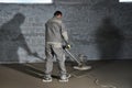 Filling the floor with concrete, screed and leveling the floor by construction workers. Smooth floors made of a mixture of cement Royalty Free Stock Photo