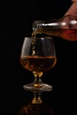 Filling a glass of brandy Royalty Free Stock Photo