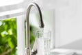 Filling glass with clear water from faucet indoors, closeup Royalty Free Stock Photo