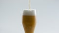 Filling glass golden beer in super slow motion close up. Lager drink pouring. Royalty Free Stock Photo