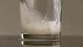 Filling glass with soda water in slow motion. Stock footage. Close up of pouring soft drink with many bubbles inside the Royalty Free Stock Photo