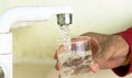 Filling glass with tap water. Modern faucet and sink. Royalty Free Stock Photo