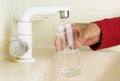 Filling glass with tap water. Modern faucet and sink. Royalty Free Stock Photo