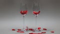 Filling the glasses with red hearts instead of wine Concept of Valentine's Day love romantic dinner for two