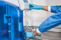 Filling a graduated cylinder with distilled water at laboratory