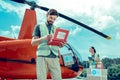 Attentive experienced bearded volunteer checking inside of first aid box