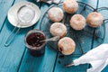 Filling homemade donuts with strawberry jam