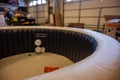 Filling an inflatable indoor hot tub inside a residential garage