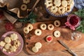 Filling Linzer Christmas cookies with red currant marmalade