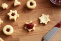Filling Linzer Christmas cookies strawberry jam