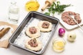 Filling of meat on pieces of raw dough on baking pan Royalty Free Stock Photo