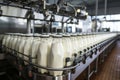 Filling milk or yogurt into plastic bottles at dairy factory equipment at dairy plant