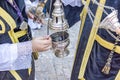 Filling one of the censers with incense