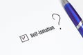 Filling out a medical checklist with a question about self-isolation. Pen and sheet of paper Royalty Free Stock Photo