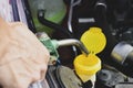 Filling the tank of windshield washer fluid Royalty Free Stock Photo