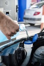 Filling the tank of windshield washer fluid Royalty Free Stock Photo