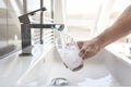 Filling up a glass with drinking water from bathroom tap Royalty Free Stock Photo