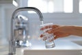 Filling up a glass with clean drinking water from kitchen faucet. Safe to drink tap water Royalty Free Stock Photo