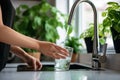 Filling up a glass with clean drinking water from kitchen faucet. Safe to drink tap water Royalty Free Stock Photo