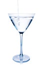 Filling a white cocktail in a glass with blue reflections Royalty Free Stock Photo