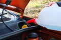 Filling windshield washer fluid in car. Driver with washer fluid in his hands, close up. Car maintenance concept Royalty Free Stock Photo