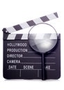 Film clapper board with magnifying glass cutout Royalty Free Stock Photo