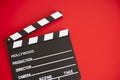 Film clapper on red background