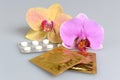 Film-coated tablets, condoms with two orchid flowers on gray