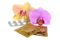 Film-coated tablets and condoms with two orchid flowers isolated