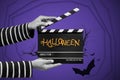 Halloween concept. Film crew holding clapperboard For filming Halloween night .