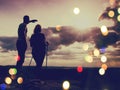 Film effect. Couple enjoying marvellous moments during sunset . Young pair of hikers on the peak Royalty Free Stock Photo