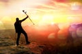 Film effect. Happy man with broken leg in immobilizer and medicine pole above head stay on peak. Open misty mountain Royalty Free Stock Photo