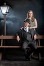 Film noir couple street lantern bench fog mist Royalty Free Stock Photo