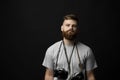 Film photography. Bearded photographer with a bunch of different vintage old film cameras. Close up portrait of man Royalty Free Stock Photo