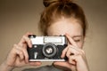 Film retro camera in the beautiful hands of young red-haired girl Royalty Free Stock Photo