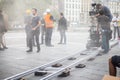 Film set production, near Notre-Dame Cathedral, director, operator, ARRI camera, trolley cart, artificial fog, actors