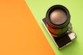 Photo camera on green and orange background