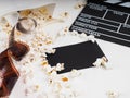 the film in the spiral, near the popcorn, Clapperboard copy space for text, fashion highlights in the photo, concept, film industr Royalty Free Stock Photo