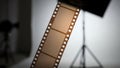 Film strip on white background with studio lighting equipment Royalty Free Stock Photo