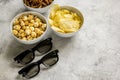 Film whatching party with glasses, crumbs, chips and pop corn stone background mockup